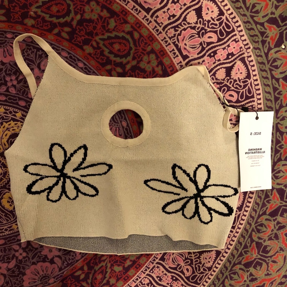 Small white crop top with flowers.